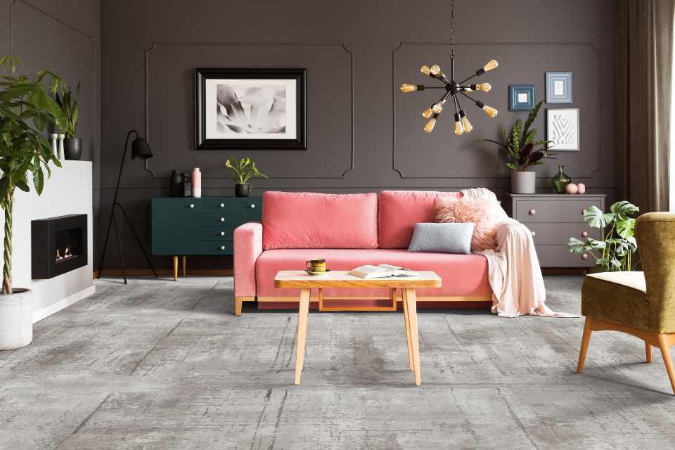 expressive gray carpet in living room with pink velvet couch
